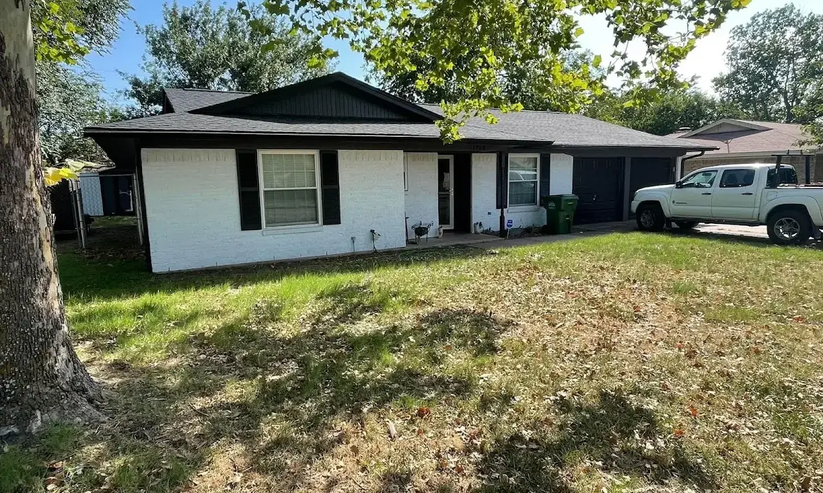 Professional roofing crew working on a residential roof in Oswego